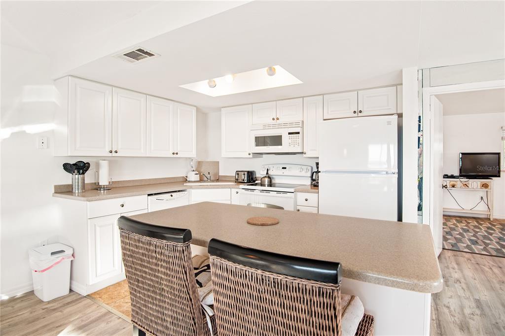 217 Casey Key Road Nokomis, FL 34275 - Photo 17 of 51 a kitchen with stainless steel appliances granite countertop a refrigerator sink and white cabinets