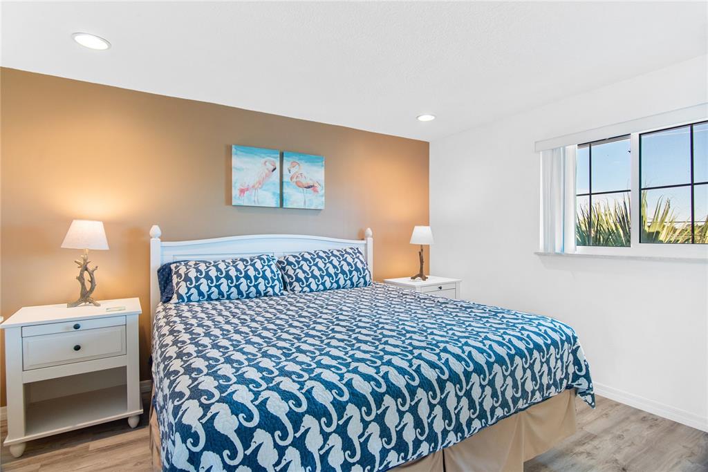 217 Casey Key Road Nokomis, FL 34275 - Photo 22 of 51 a bedroom with a bed and a lamp