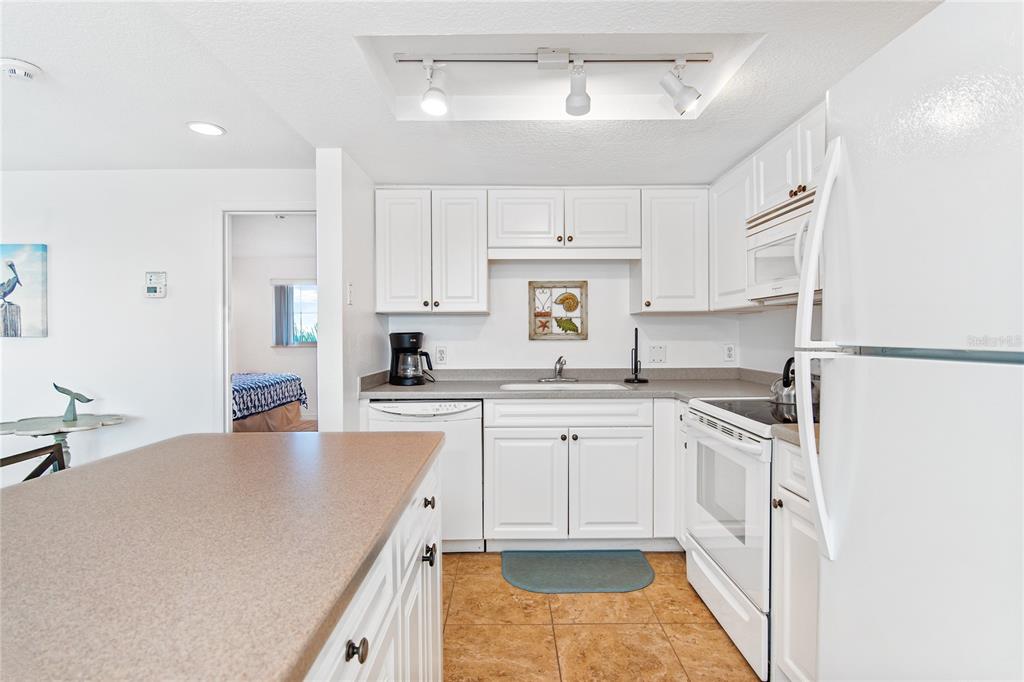217 Casey Key Road Nokomis, FL 34275 - Photo 24 of 51 a kitchen with stainless steel appliances granite countertop a sink and cabinets