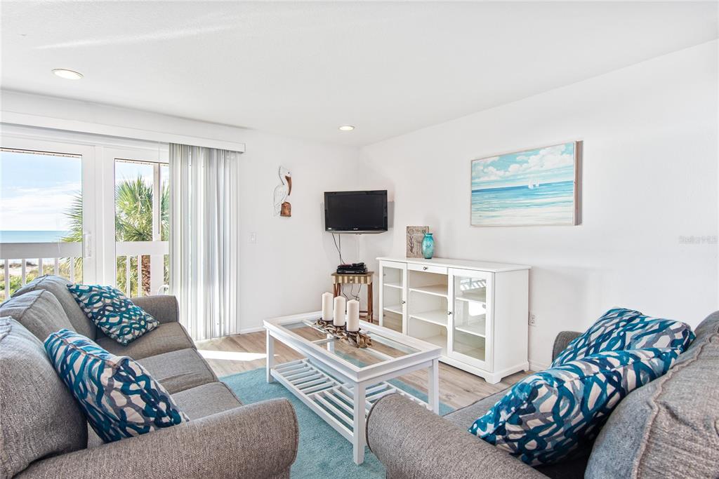 217 Casey Key Road Nokomis, FL 34275 - Photo 26 of 51 a living room with furniture and a flat screen tv