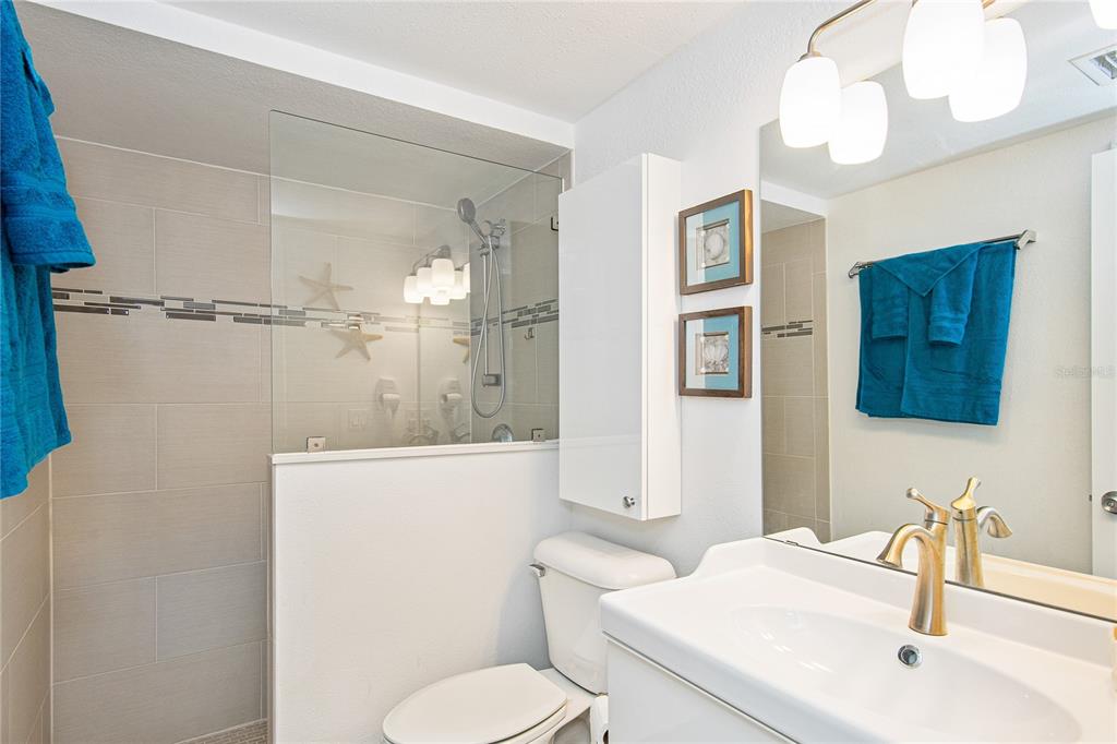 217 Casey Key Road Nokomis, FL 34275 - Photo 29 of 51 a bathroom with a sink a toilet and shower