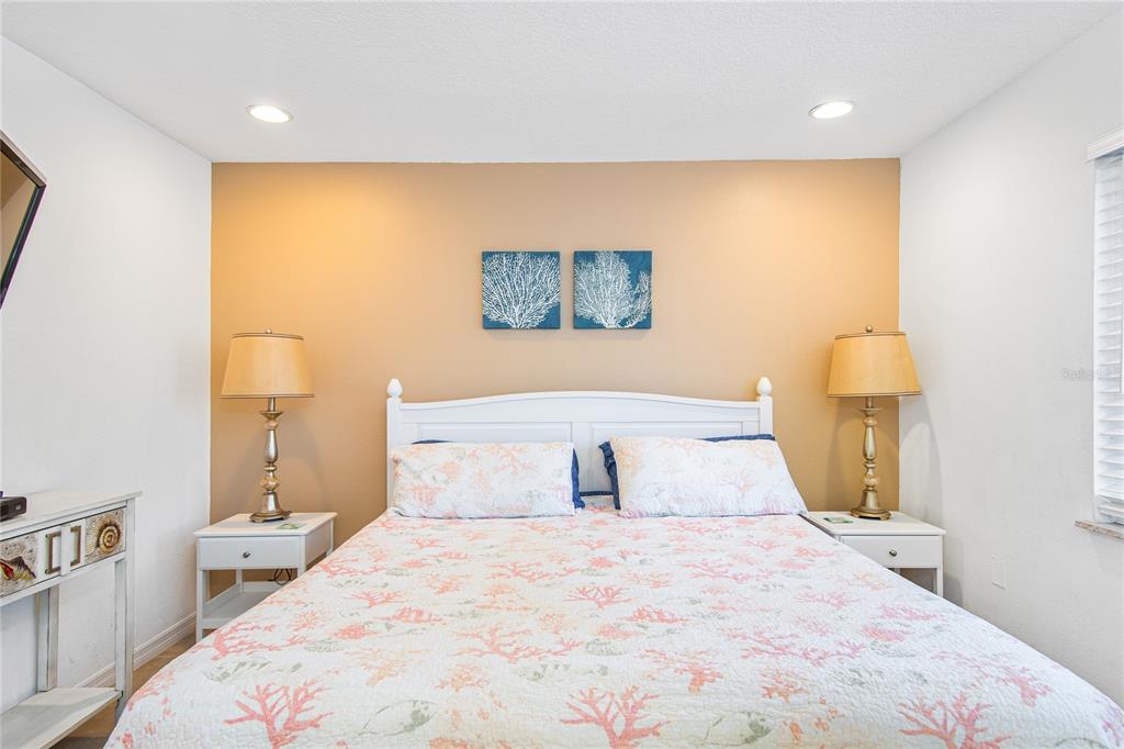 217 Casey Key Road Nokomis, FL 34275 - Photo 30 of 51 a bedroom with a bed and a painting on the wall