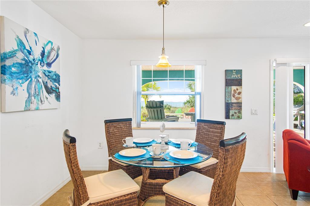 217 Casey Key Road Nokomis, FL 34275 - Photo 31 of 51 a dining room with furniture a window and wooden floor