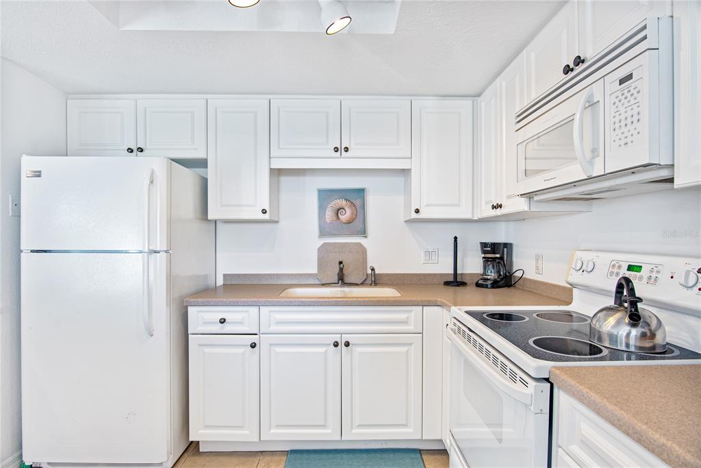 217 Casey Key Road Nokomis, FL 34275 - Photo 32 of 51 a kitchen with appliances a sink and cabinets
