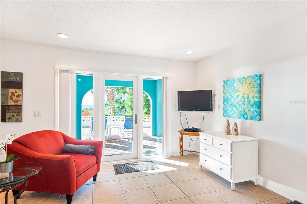 217 Casey Key Road Nokomis, FL 34275 - Photo 33 of 51 a bedroom with furniture and a flat screen tv