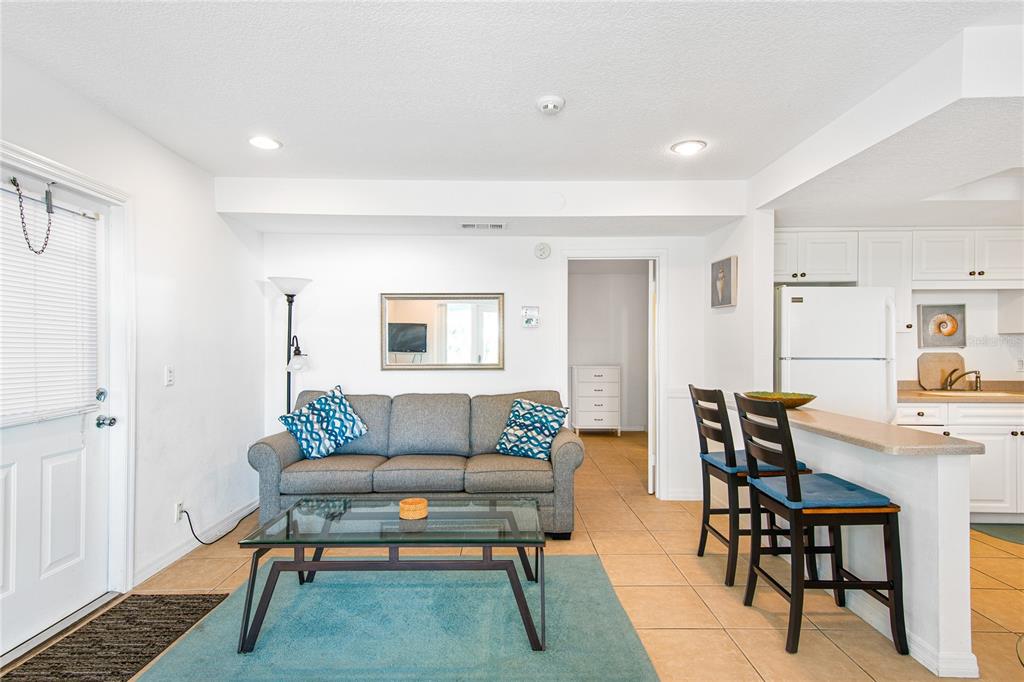 217 Casey Key Road Nokomis, FL 34275 - Photo 34 of 51 a living room with furniture a rug and a window