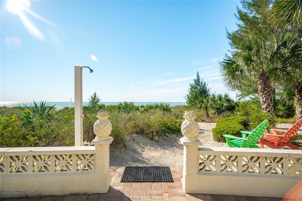217 Casey Key Road Nokomis, FL 34275 - Photo 8 of 51 a wooden bench sitting in front of a building
