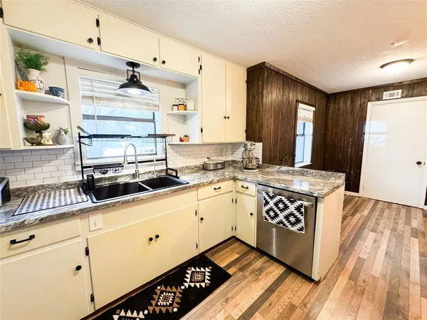 a kitchen with a sink a stove and cabinets