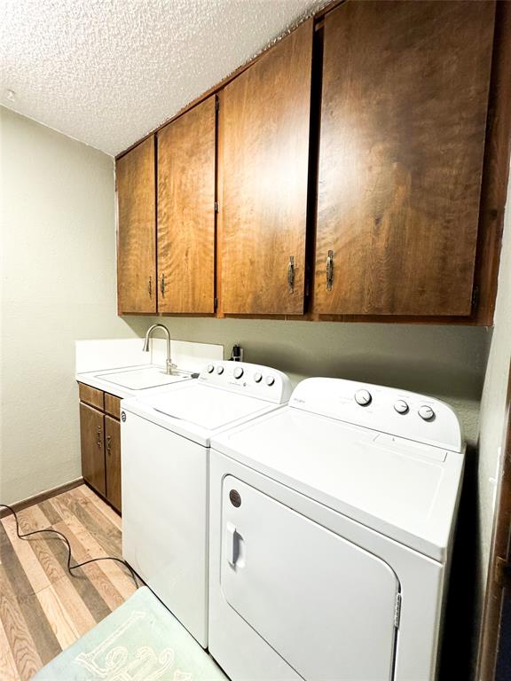 1303 Grand Central Avenue O'Brien, TX 79539 - Photo 16 of 40 a utility room with dryer and washer