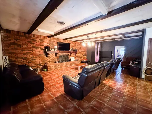 a living room with fireplace furniture and a flat screen tv