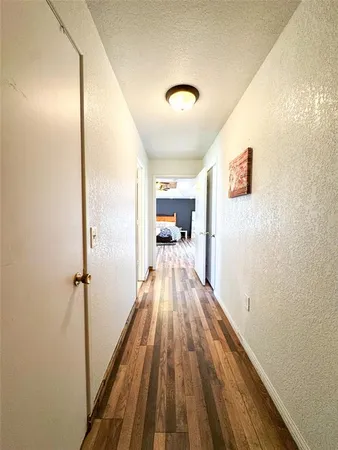 a view of a hallway view with wooden floor and staircase