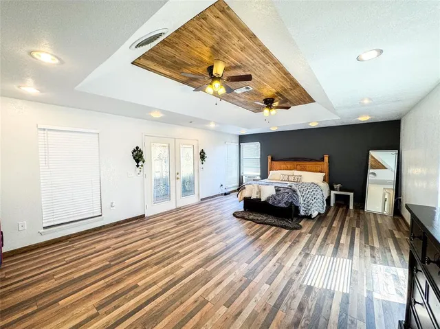a bedroom with furniture and a wooden floor