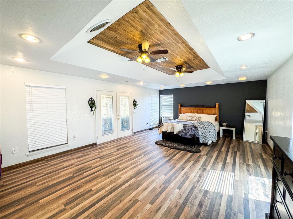 1303 Grand Central Avenue O'Brien, TX 79539 - Photo 27 of 40 a bedroom with furniture and a wooden floor