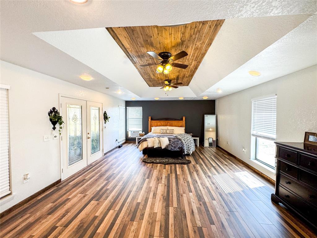 1303 Grand Central Avenue O'Brien, TX 79539 - Photo 28 of 40 a bedroom with a bed and wooden floor