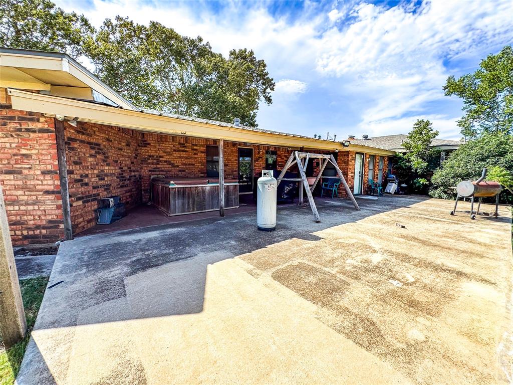 1303 Grand Central Avenue O'Brien, TX 79539 - Photo 32 of 40 a view of outdoor space yard deck and slide