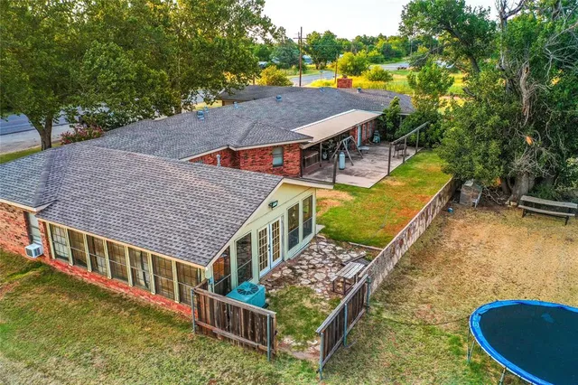a view of a house with a yard and a garden