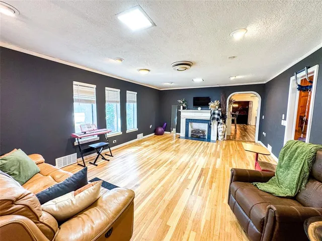 a living room with furniture fireplace and flat screen tv