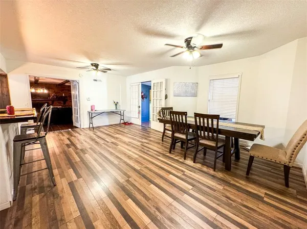 a view of a a dining room with furniture window and wooden floor