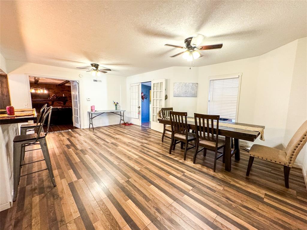 1303 Grand Central Avenue O'Brien, TX 79539 - Photo 8 of 40 a view of a a dining room with furniture window and wooden floor