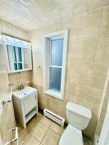a bathroom with a sink a toilet and a mirror