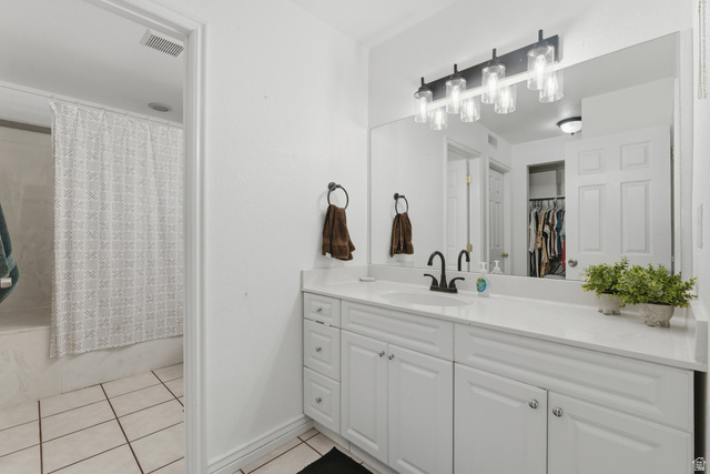 282 West 960 South, Unit C Provo, UT 84601 - Photo 15 of 33 Bathroom featuring vanity, light tile patterned flooring, shower / tub combo with curtain, and a spacious closet