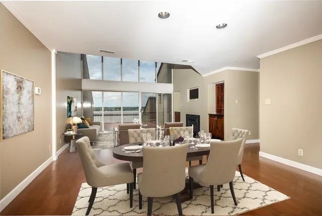 a dining room with furniture a painting and wooden floor