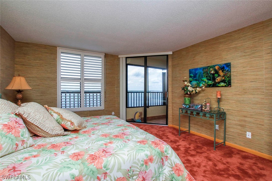 15021 Punta Rassa Road, Unit 602 Fort Myers, FL 33908 - Photo 11 of 35 a bedroom with a bed and a flat screen tv