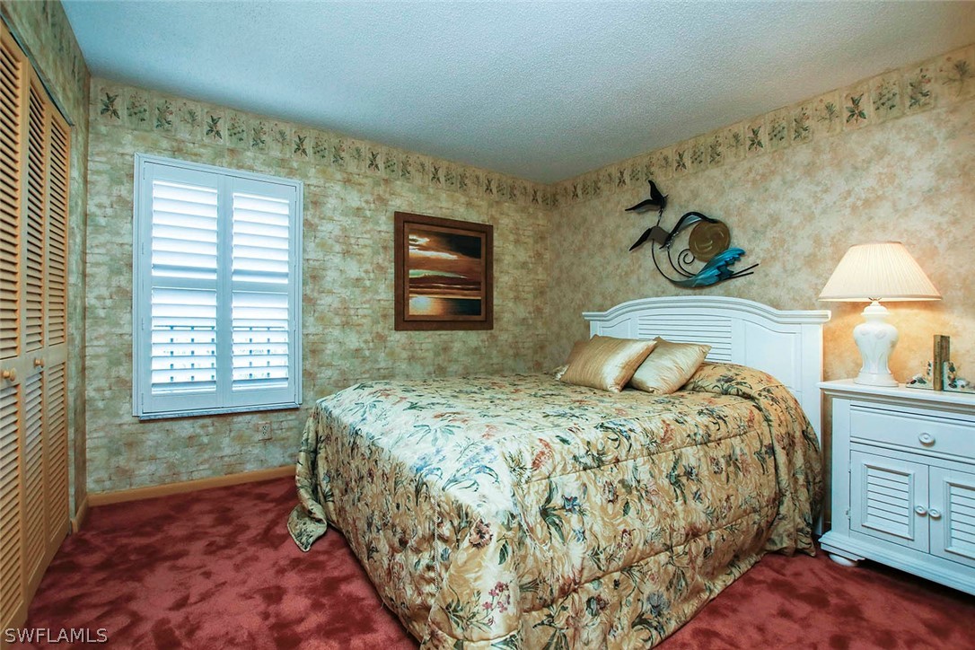 15021 Punta Rassa Road, Unit 602 Fort Myers, FL 33908 - Photo 16 of 35 a bedroom with a bed and a window