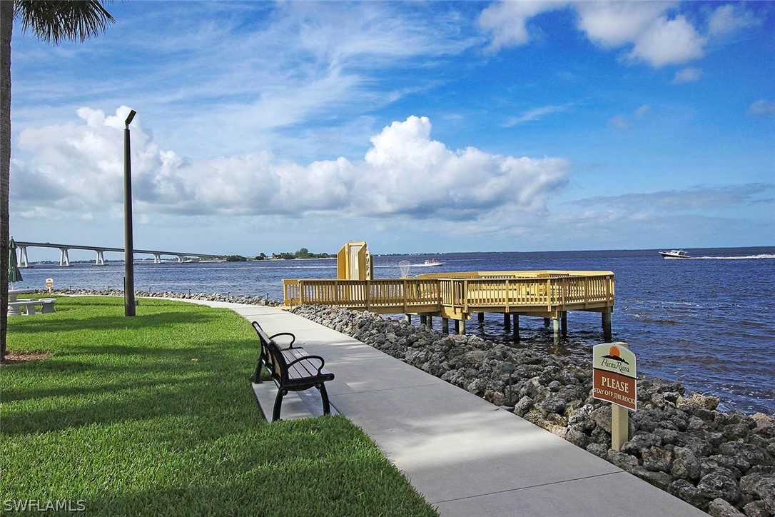 15021 Punta Rassa Road, Unit 602 Fort Myers, FL 33908 - Photo 26 of 35 a view of a garden with a bench