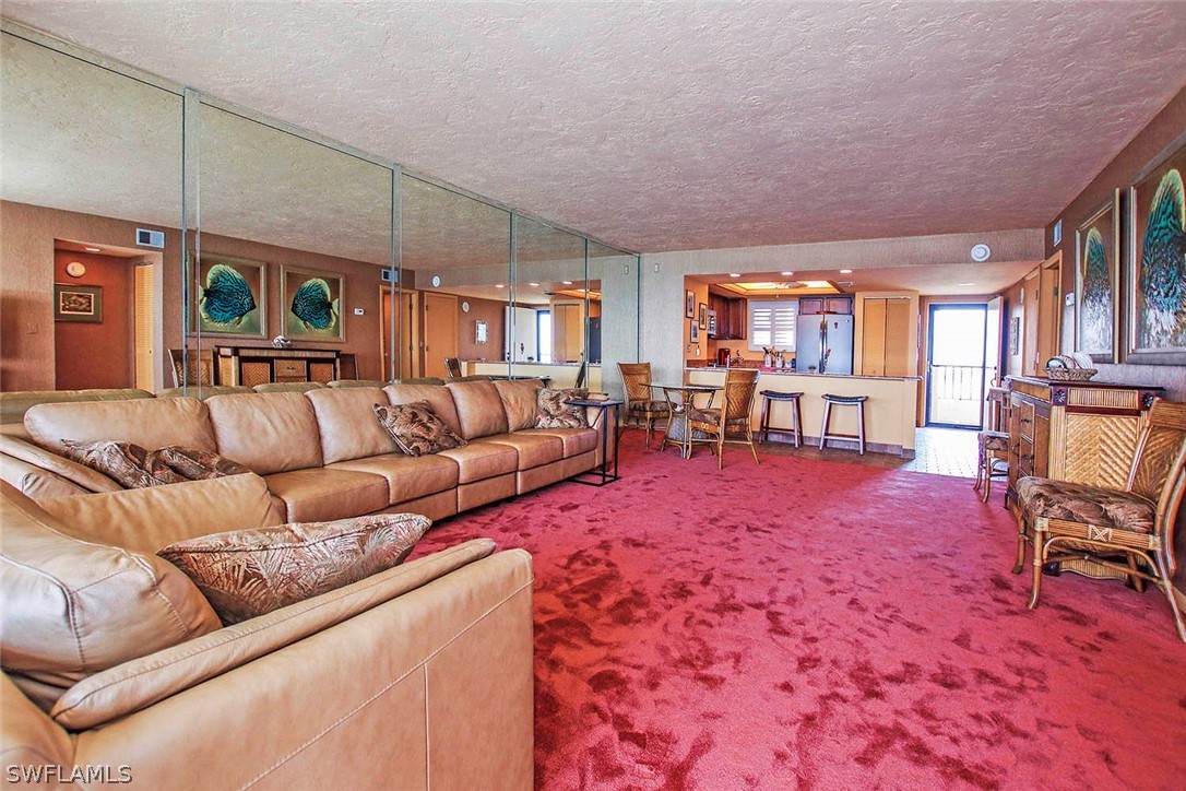 15021 Punta Rassa Road, Unit 602 Fort Myers, FL 33908 - Photo 3 of 35 a living room with furniture and a dining table
