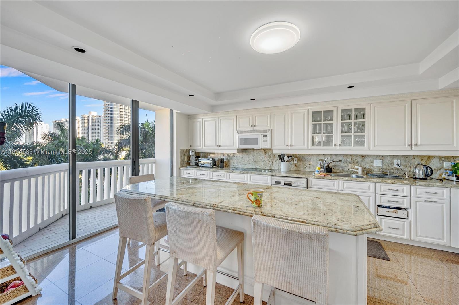 2000 Island Boulevard, Unit 806 Aventura, FL 33160 - Photo 9 of 30 a kitchen with counter top space cabinets and appliances
