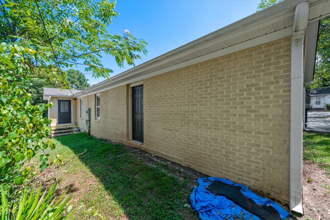 412 Sanders Street Anderson, SC 29624 - Photo 27 of 30 A classic brick exterior with well-maintained siding offers enduring curb appeal.
