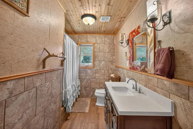 a bedroom with a bed a computer on the desk and chair