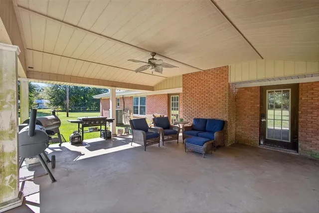 a view of a patio with couches chairs and potted plants