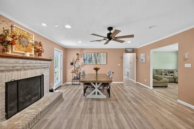 a living room with a fireplace and a floor to ceiling window
