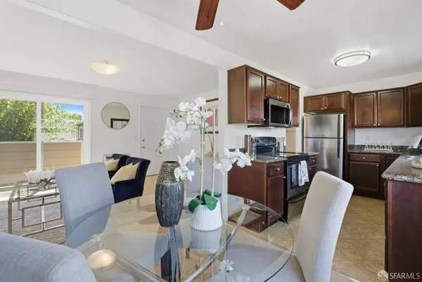 a kitchen with stainless steel appliances granite countertop a sink stove microwave refrigerator and stove