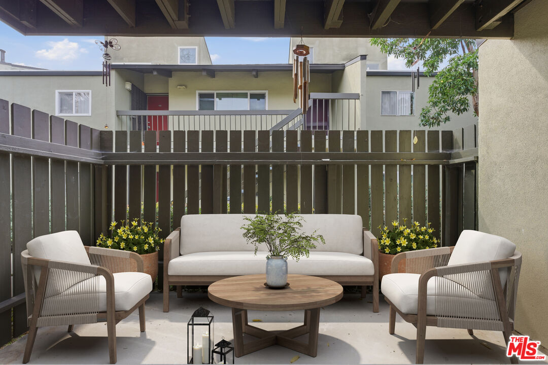 4836 Hollow Corner Road, Unit 312 Culver City, CA 90230 - Photo 14 of 29 a view of a patio with couches table and chairs and potted plants