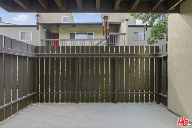a view of a house with a wooden fence
