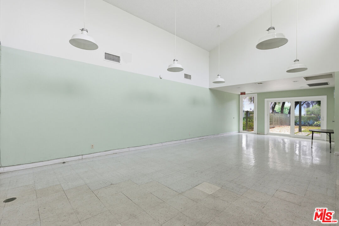 4836 Hollow Corner Road, Unit 312 Culver City, CA 90230 - Photo 25 of 29 an empty room with chandelier fan and windows