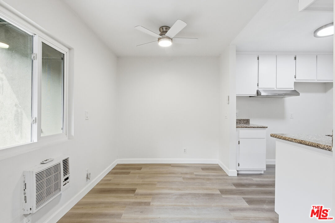 4836 Hollow Corner Road, Unit 312 Culver City, CA 90230 - Photo 4 of 29 an empty room with wooden floor and window