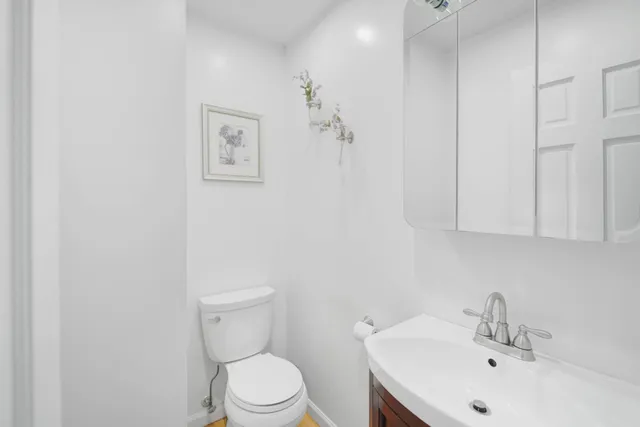 a bathroom with a sink mirror and toilet