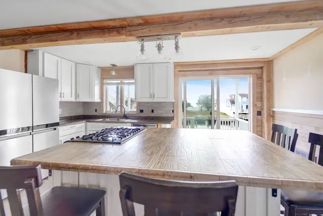 a kitchen with a table chairs refrigerator and cabinets
