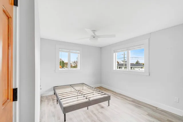 a view of room with window and a ceiling fan