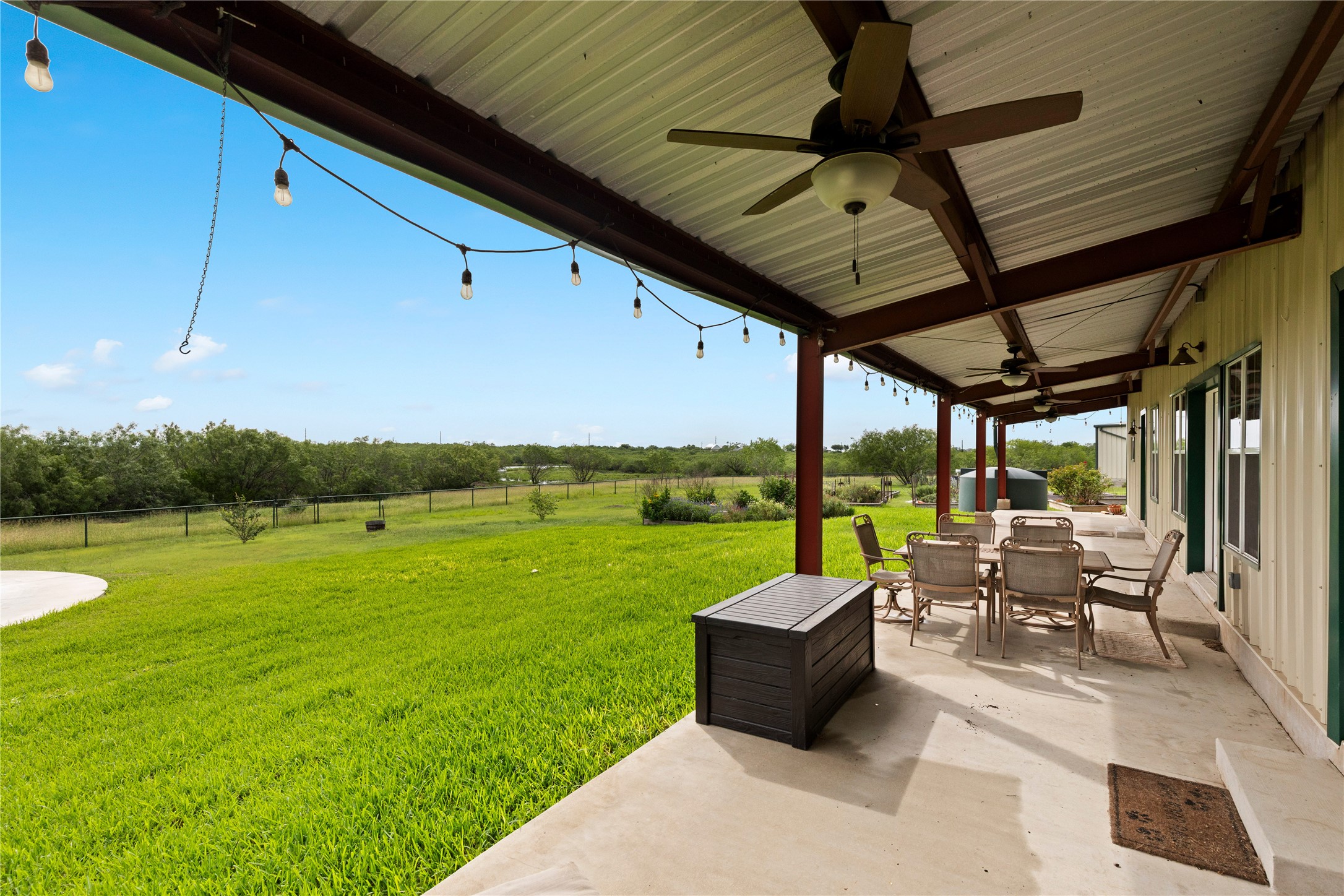 1293 Pioneer Road Seguin, TX 78155 - Photo 6 of 40 An inviting covered patio provides ample space for outdoor living and views of the verdant yard.