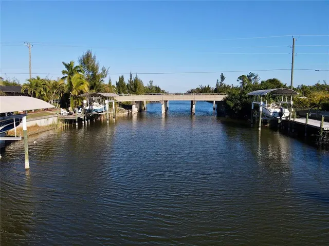 a view of a ocean with boats and trees in the background