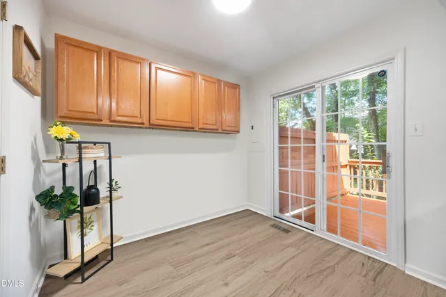 a view of a room with wooden floor and windows