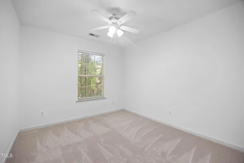 a bathroom with a granite countertop sink a toilet and a mirror