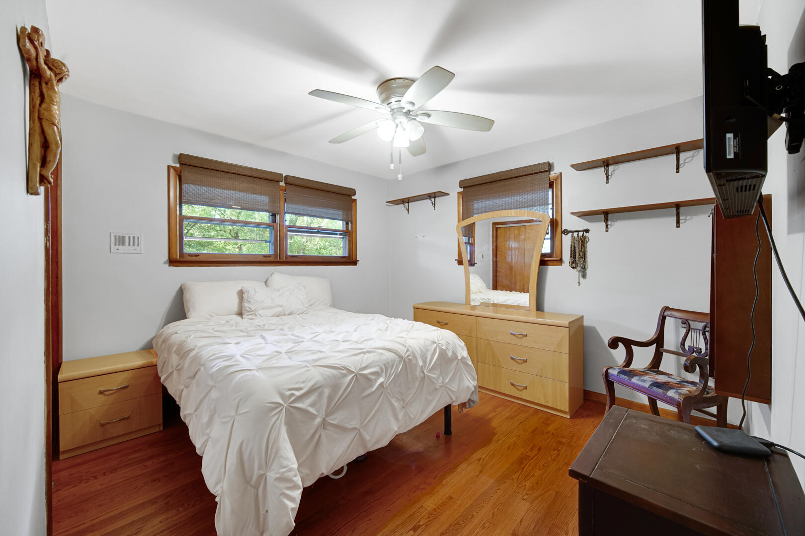 5001 Marquette Road Lake Station, IN 46405 - Photo 13 of 32 a bedroom with a bed and a table with wooden floor