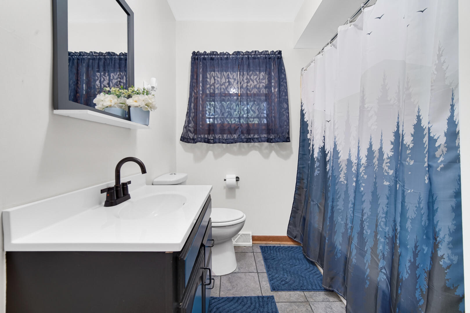 5001 Marquette Road Lake Station, IN 46405 - Photo 17 of 32 a bathroom with a sink a toilet and shower