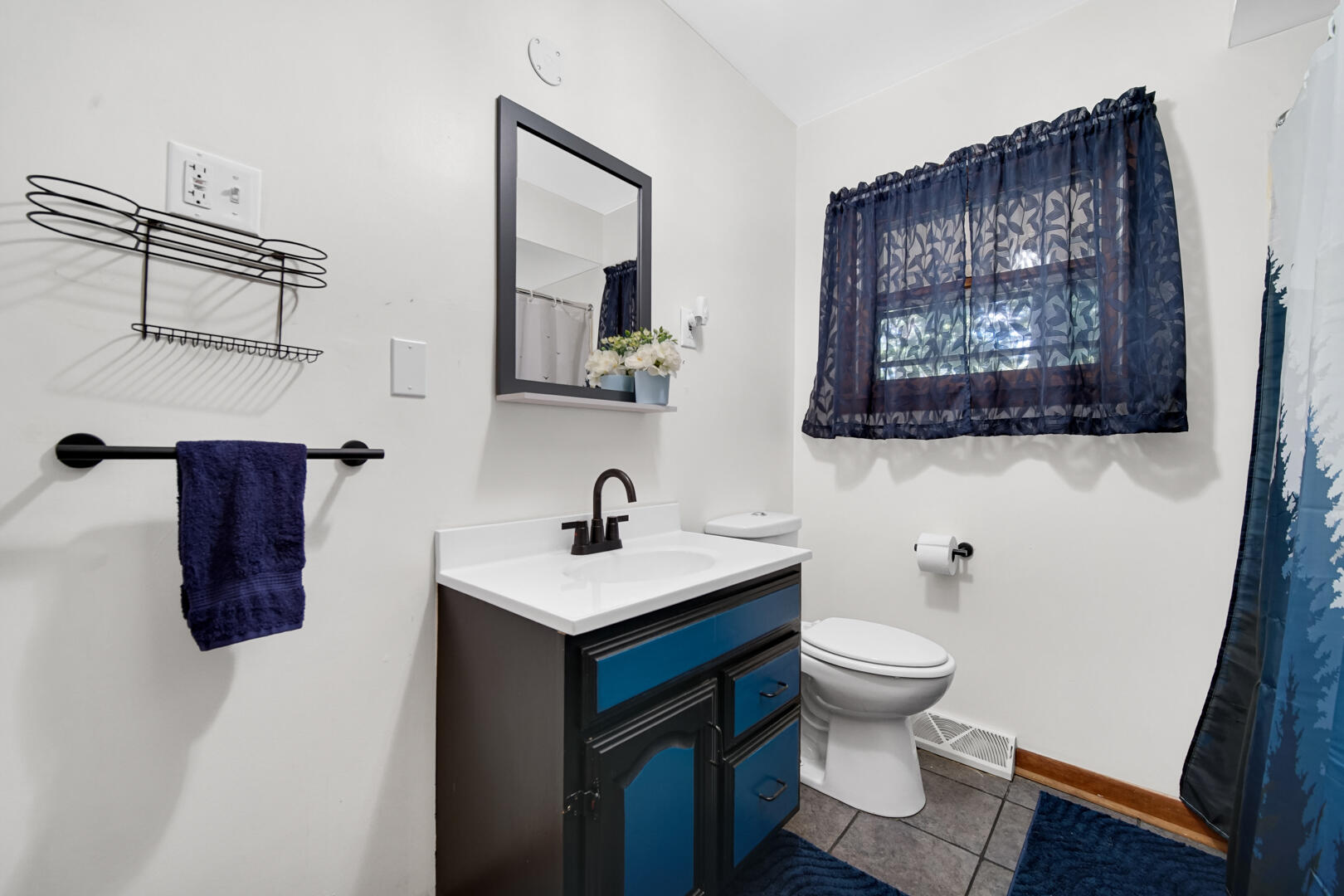 5001 Marquette Road Lake Station, IN 46405 - Photo 18 of 32 a bathroom with a toilet a sink and mirror